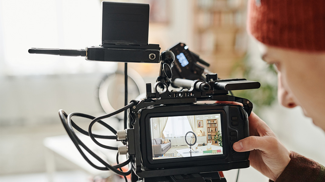 Film crew camera setup capturing a residential interior, representing housing logistics for production and touring teams