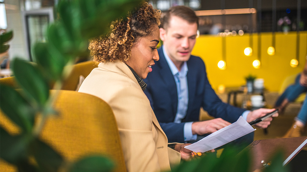 Business professional reviewing documents during a corporate housing consultation with a supplier partner.